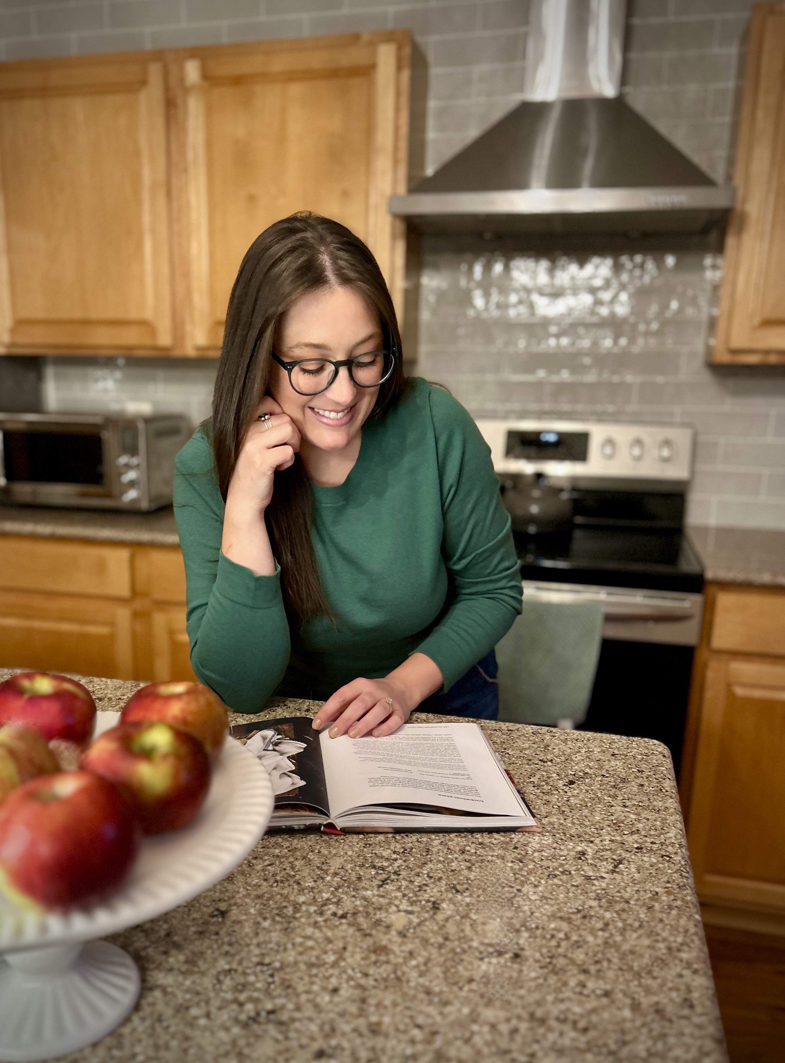 business owner reading recipe book at kitchen island
